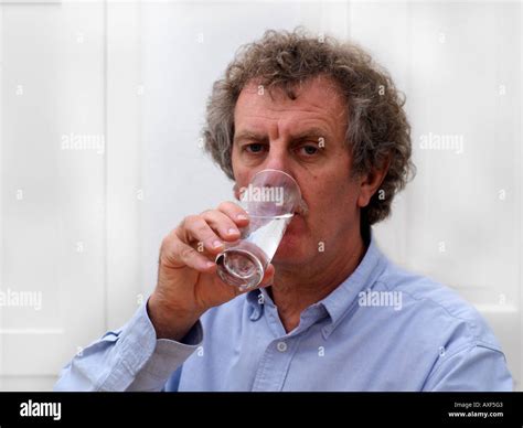 Man Drinking Glass Of Water Stock Photo Alamy