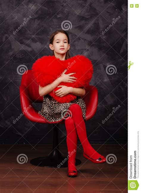 Pretty Little Girl Wearing Beautiful Dress Sitting In Red Armchair She