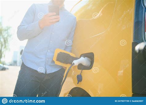 Man Charging His Electric Car At Charge Station Stock Image Image Of