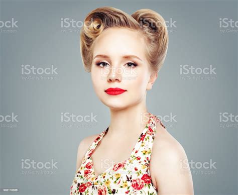 Beautiful Woman With Retro Vintage Pinup Hairstyle And Makeup Against