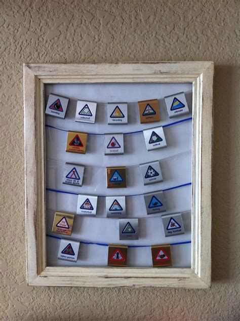 Display For Cub Scout Belt Loops Using A Picture Frame And Boondoggle