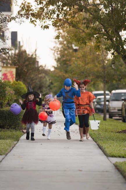 Street Scene Of Children Going Trick Or Treating — Disguise Outdoors