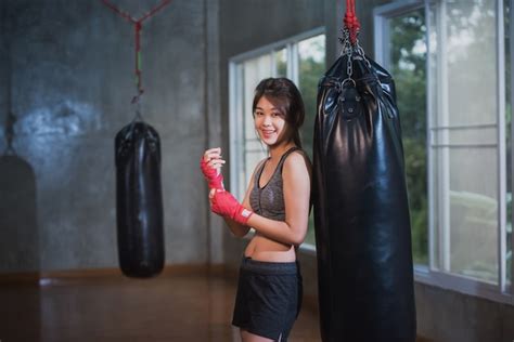 premium photo sexy asia girl punching boxing bag