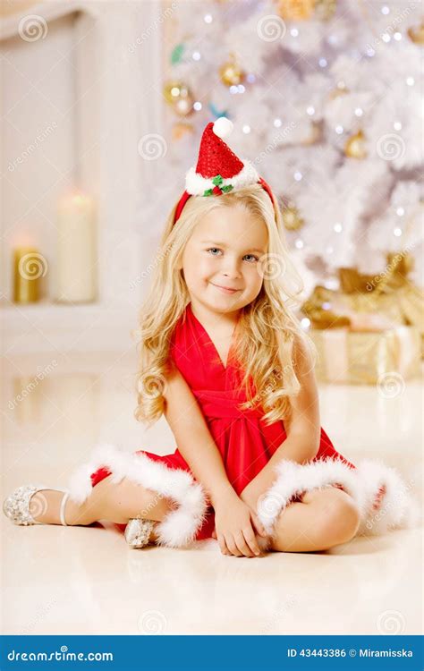 Beautiful Little Santa Girl Near The Christmas Tree Happy Girl Stock