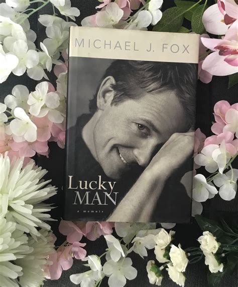 The Book Lucky Man By Michael J Fox Surrounded By Pink And White