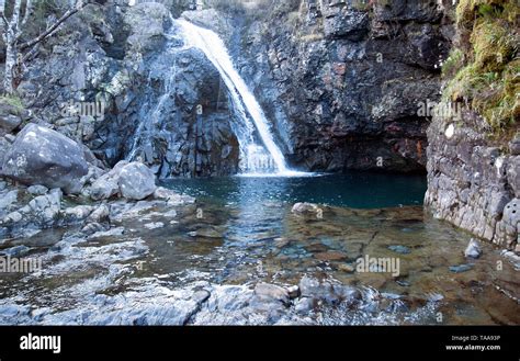 A Fairy Pool With A Clear Waters Fed By A Waterfall Along The River