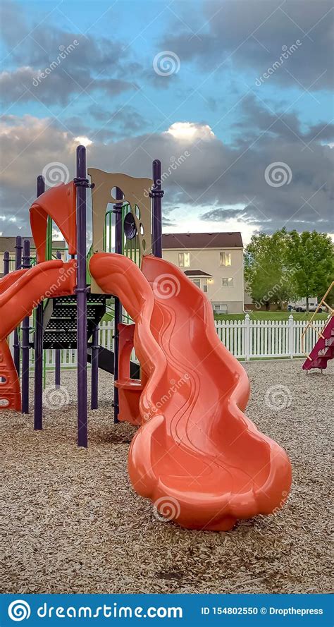 Vertical Frame Neighborhood Playground With Bright Colorful Slides And