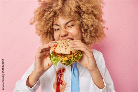 Tasty Unhealthy Meal Hungry Curly Haired Young Woman Bites Delicious Hamburger Break Diet Wears