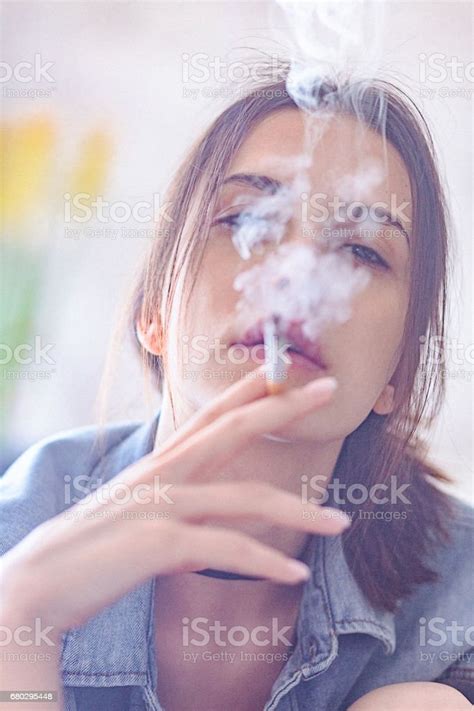 Portrait Of Beautiful Rebellious Brunette Woman Smoking Cigarette At