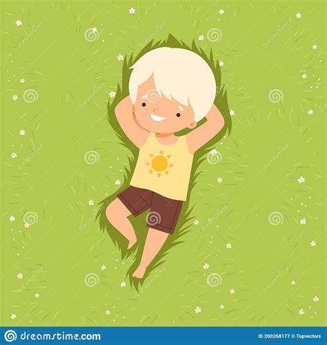 Adorable Smiling Boy Lying Down On Green Lawn Cute Kid Lying On Grass
