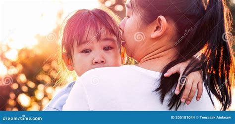 Mother Comforting Her Crying Little Girl In The Park Parenthood
