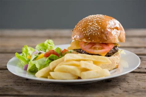 Close Up Of Burger And French Fries With Vegetables Stock Image Image