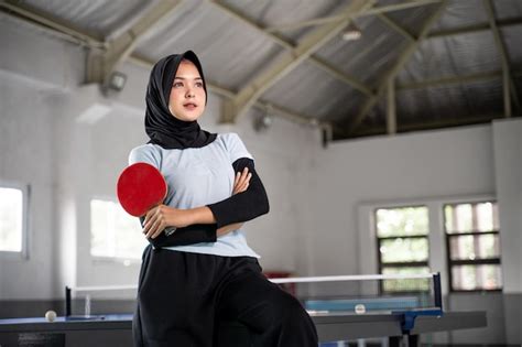 Premium Photo Female Table Tennis Athlete In Hijab Holding Bat With