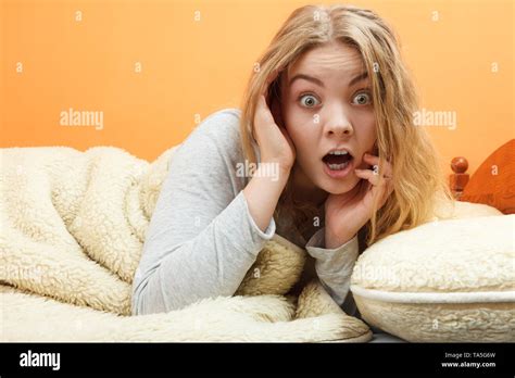 Surprised Woman Waking Up In Bed In The Morning After Sleeping Young