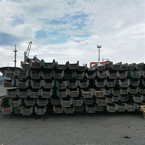 A Large Stack Of Steel Bars Sitting On Top Of A Brick Road