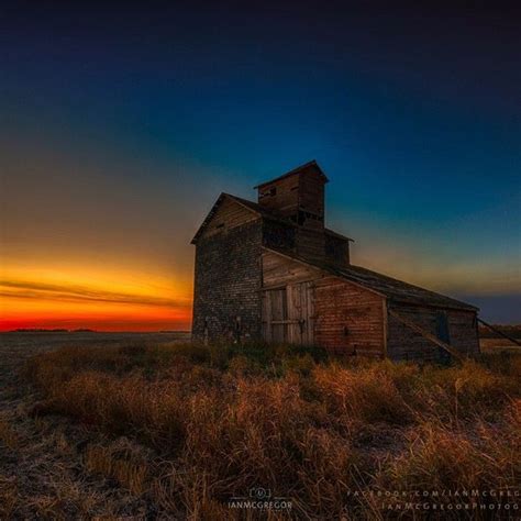 Dawn On The Saskatchewan Prairie Looking Over An Old Farm Building