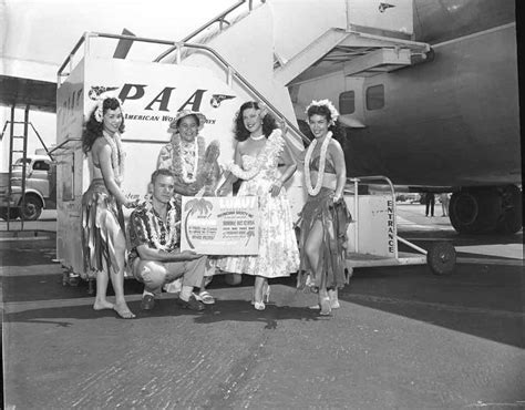 1954 hula girls pose by the stairway to a pan am boeing 377 stratocruiser pan american airways