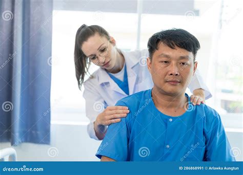 Female Doctor Doing Physiotherapy Stretching Male Patient S Shoulder
