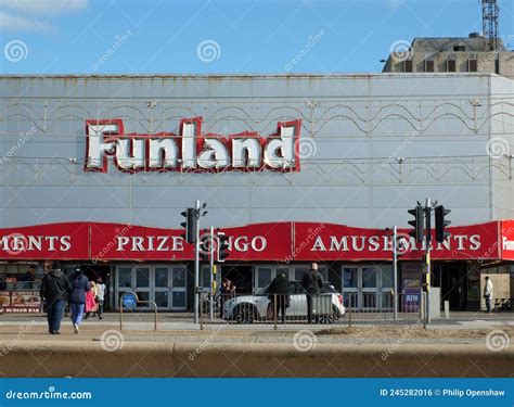 Sign Above The Funland Amusement Arcade In Blackpool With People