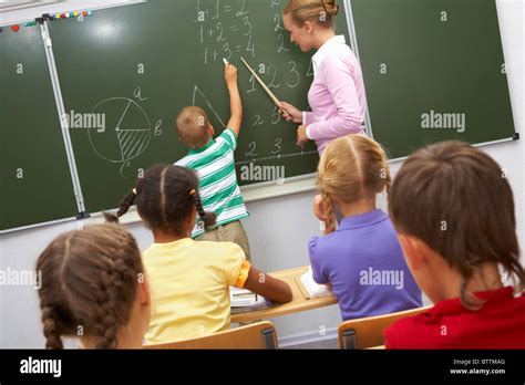 Children Writing On Blackboard High Resolution Stock Photography And