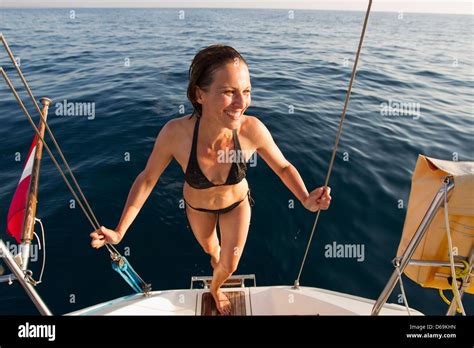 Woman In Bikini Climbing Into Boat Stock Photo Alamy