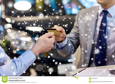 When we bought my husband's car, we were capped at charging $5,000 of it, which is a common limit. Customer Giving Credit Card To Car Dealer In Salon Stock Photo - Image of hand, business: 63398324