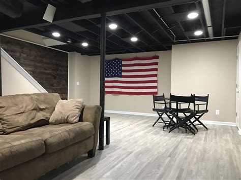 A Living Room Filled With Furniture And An American Flag Hanging On The