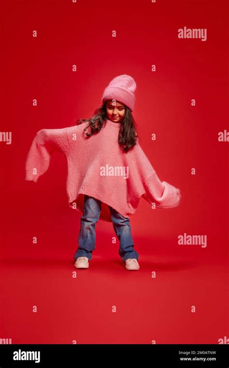 Portrait Of Cute Little Girl Child Posing In Oversized Pink Sweater