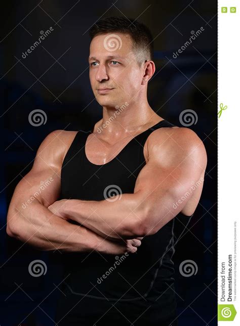 Handsome Athletic Fitness Man Posing And Trains In The Gym Stock Photo