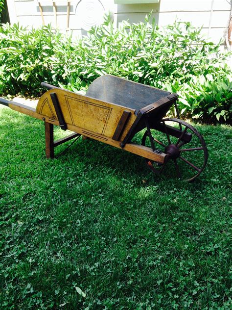 An Old Wooden Wagon Sitting In The Grass