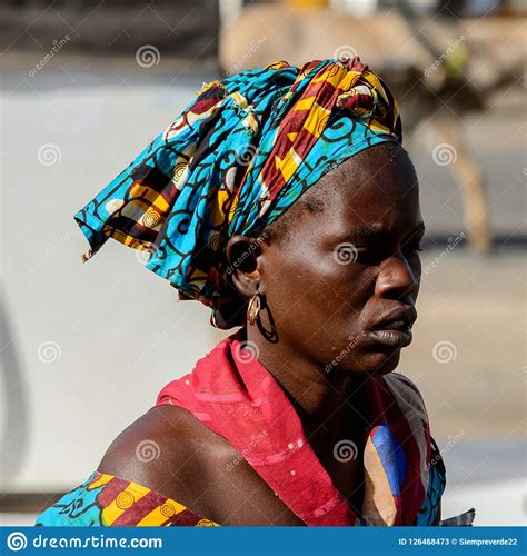 Unidentified Senegalese Woman In Colored Headscarf Looks Ahead