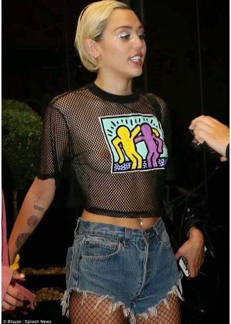 MILEY CYRUS SUFFERS WARDROBE MALFUNCTION AS SHE FLASHES NIPPLE TO FAN