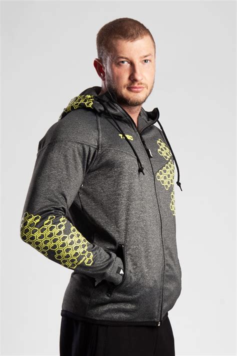 Stylish man with muscular torso wearing hoodie. HOODIE ZIP 002 - DARK GREY | Trec Nutrition
