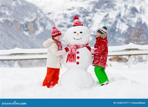 Child Building Snowman Kids Build Snow Man Stock Image Image Of