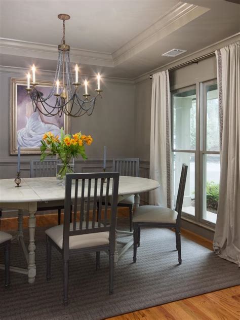 Two convenient drawers keep dining essentials close at hand. Traditional Gray Dining Room With Antique Chandelier | HGTV
