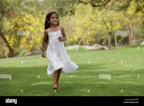 Little Girl Running In Park Stock Photo Alamy