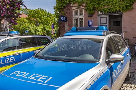 Two German Police Cars Parking In Front Of The Police Station Of A