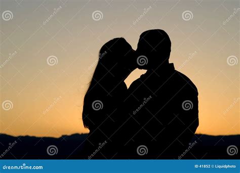 Silhouette Of Couple Kissing