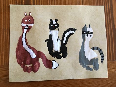 Woodland Animal Hand And Foot Print Art A Fox A Skunk And A Raccoon