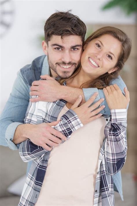 Happy Young Couple Hugging Indoors Stock Photo Image Of Home Male