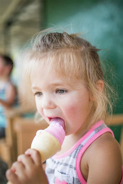 Young Cute Girl Happily Licking Pink Ice Cream On Summer Day Photograph By Cavan Images Pixels