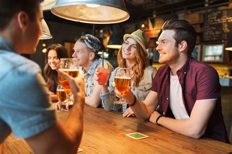 Happy Friends With Drinks Talking At Bar Or Pub Aliprandi Beverage