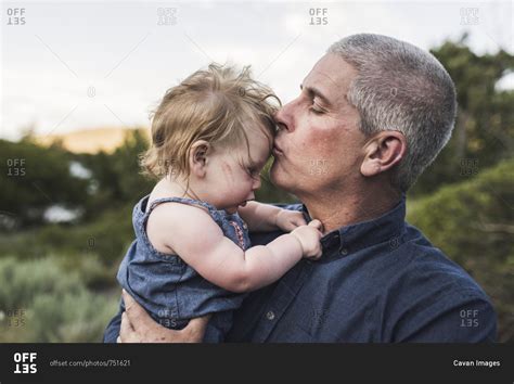 Close Up Of Father Kissing On Daughters Forehead While Standing