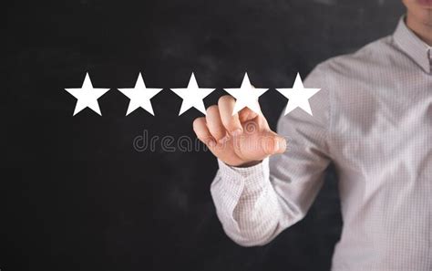 A Man Clicks On The Icon Of The Stars Concept Evaluation Stock Image