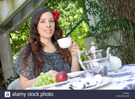 Young Woman Drinking Tea In Garden Stock Photo Alamy