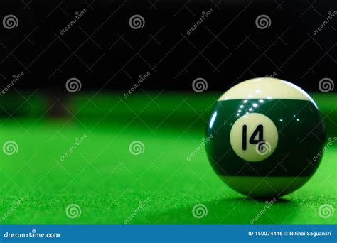 Close Up Photos Of Billiard Ball Number 14 And Green Floor Stock Photo