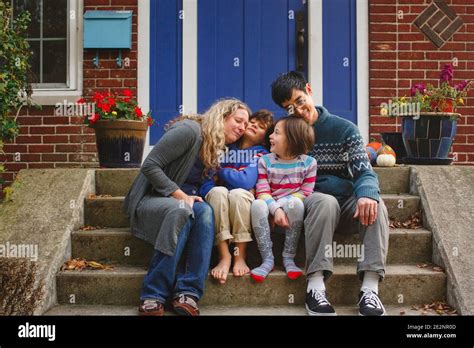 Boy And Girl Sitting In Front Of A House Hi Res Stock Photography And