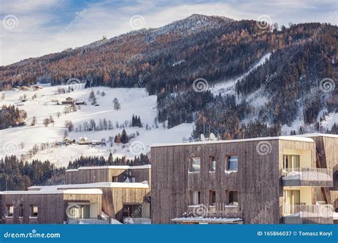 New Mountain Wooden Houses With Snow Capped Roofs And Mountains In