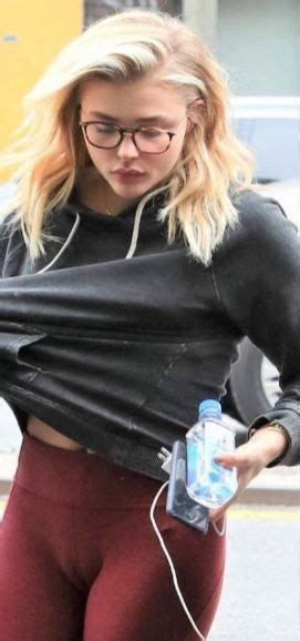 A Woman In Black Shirt And Red Leggings With Water Bottle On Her Hip