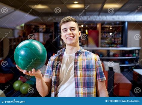 Happy Young Man Holding Ball In Bowling Club Stock Photo Image Of